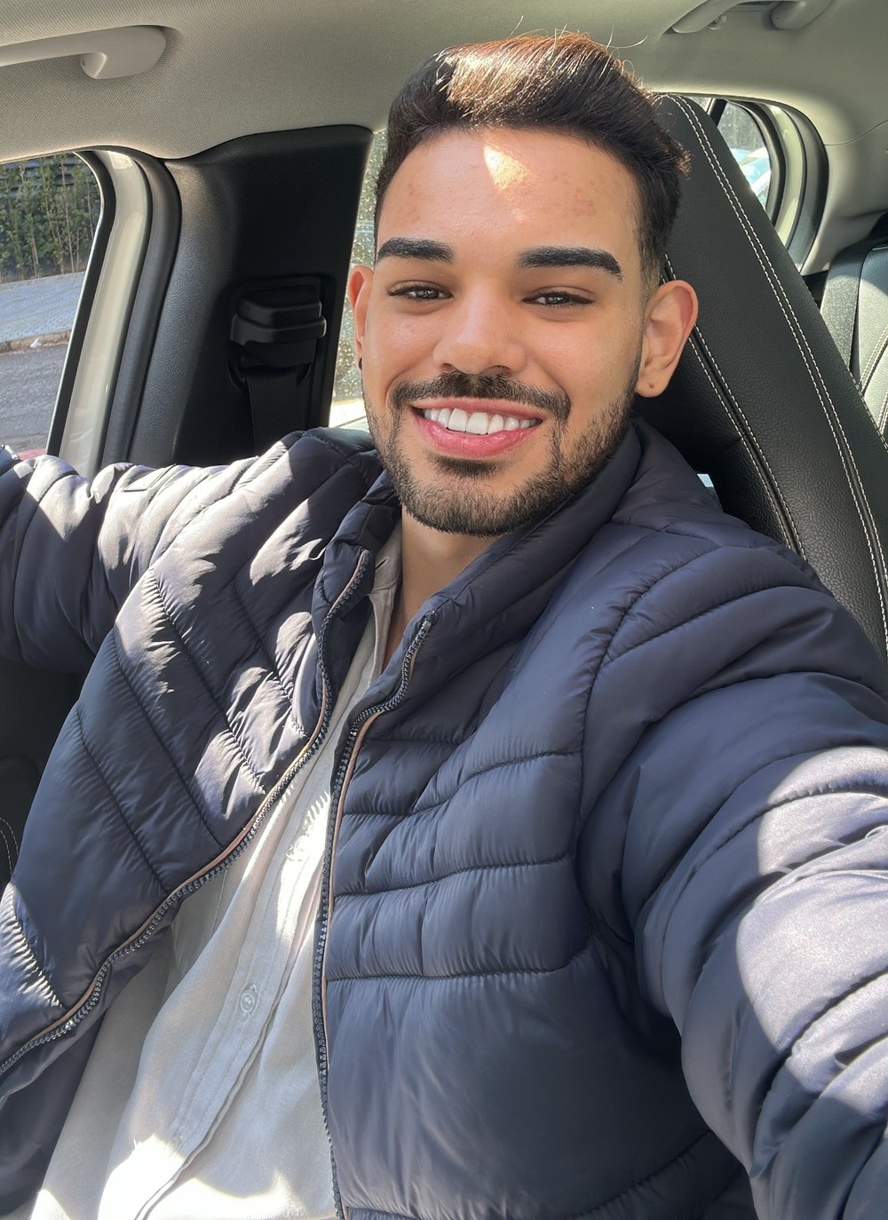 Denner Vieira sorrindo ao volante